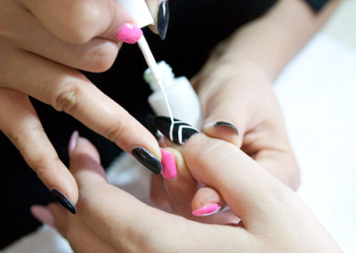 Fantastic Nails and Spa team member applying nail art design