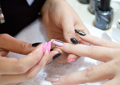 Fantastic Nails and Spa team member applying nail art design